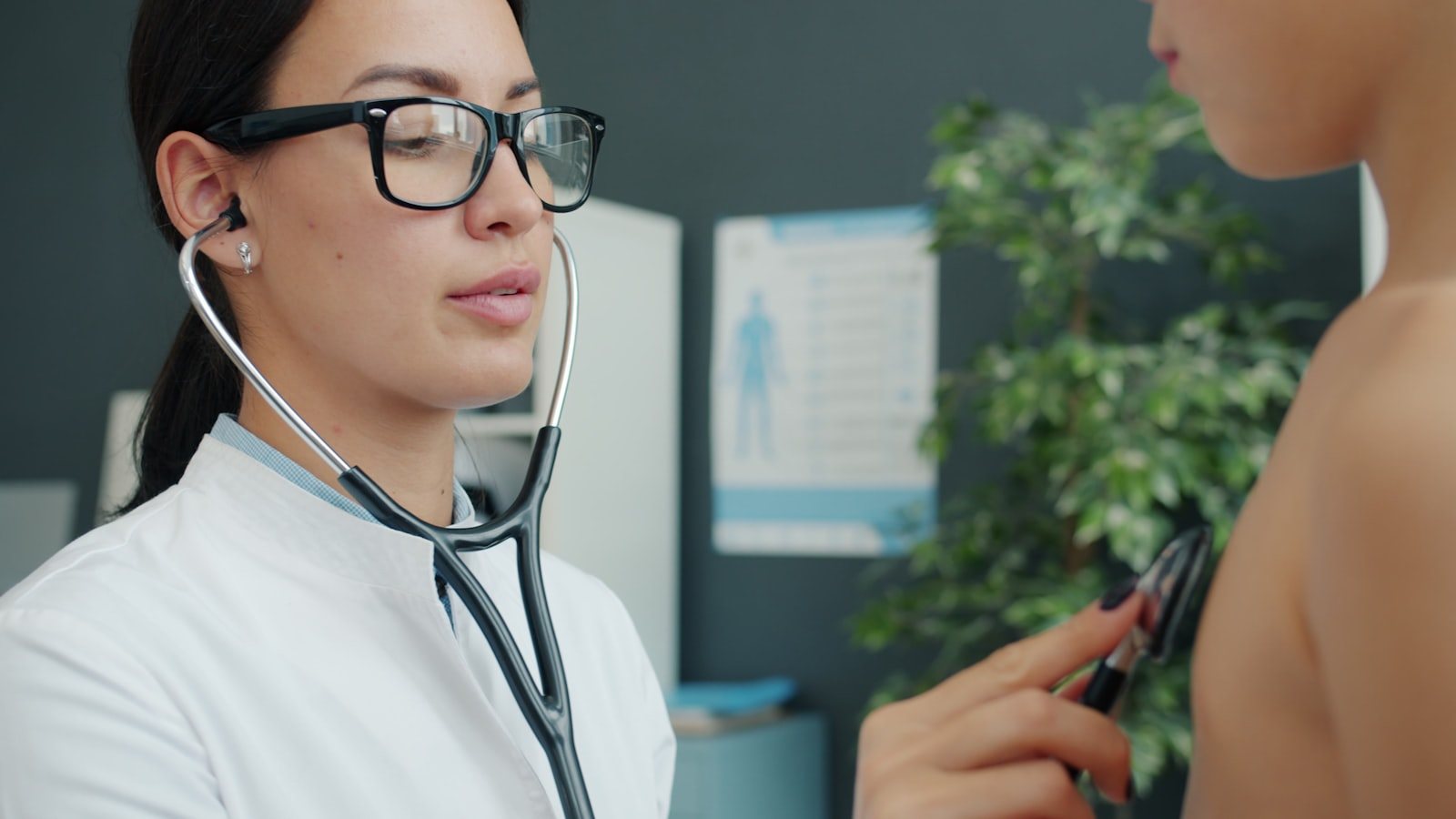 A clinician examining a patient during a consultation