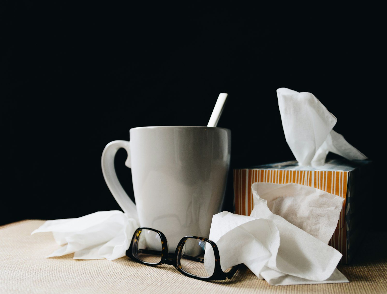 A person resting at home with a hot drink