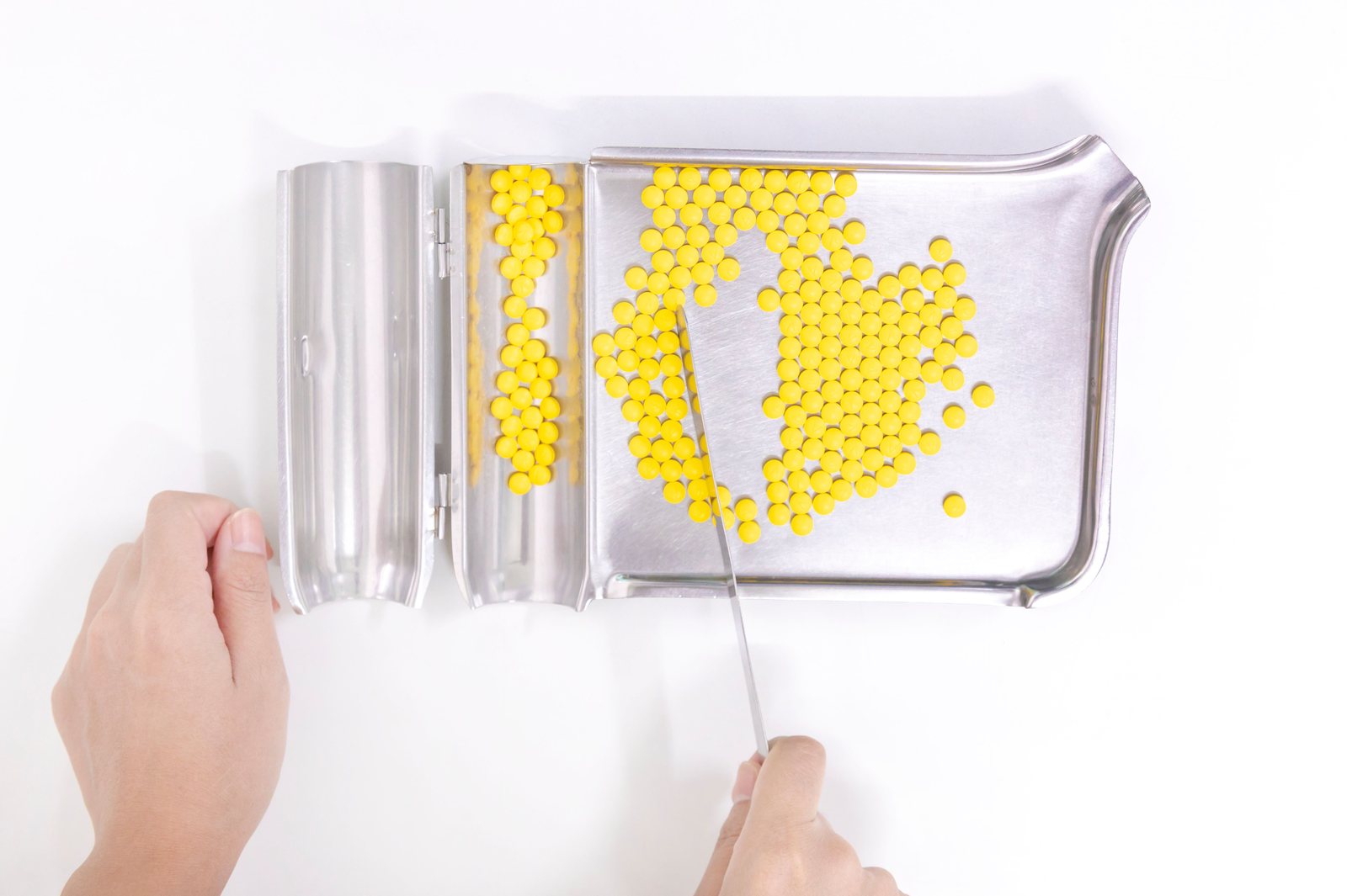 Capsules being dispensed on a pharmacy tray