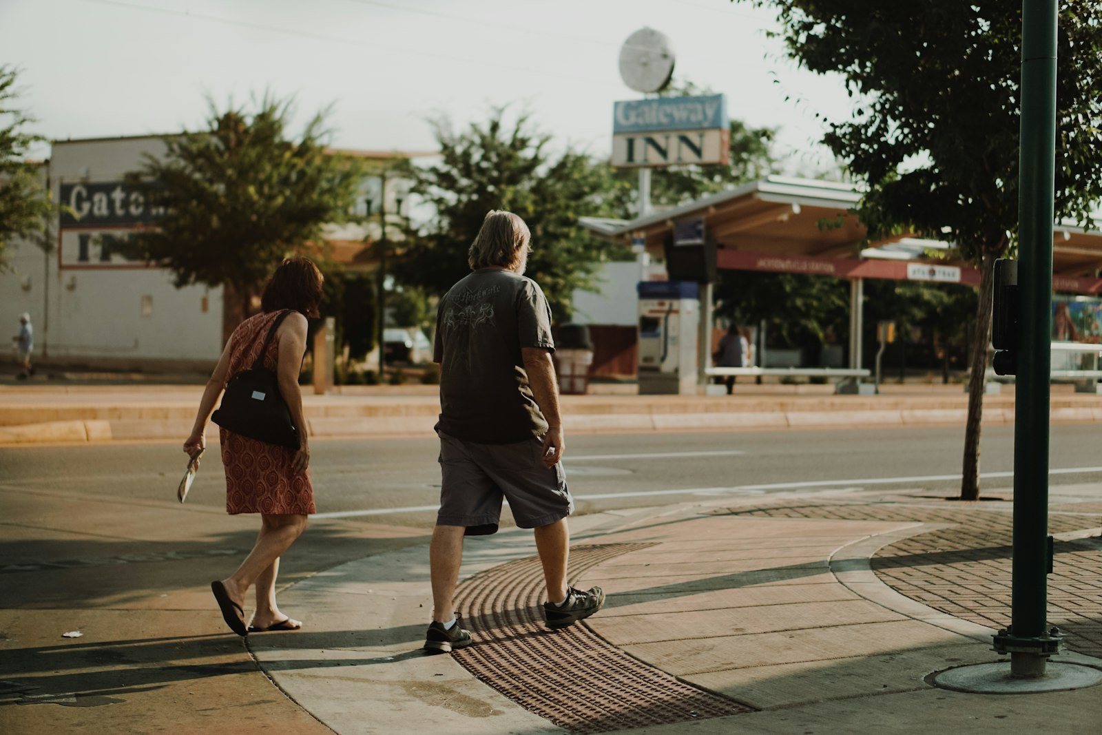 Two people walking on a city street