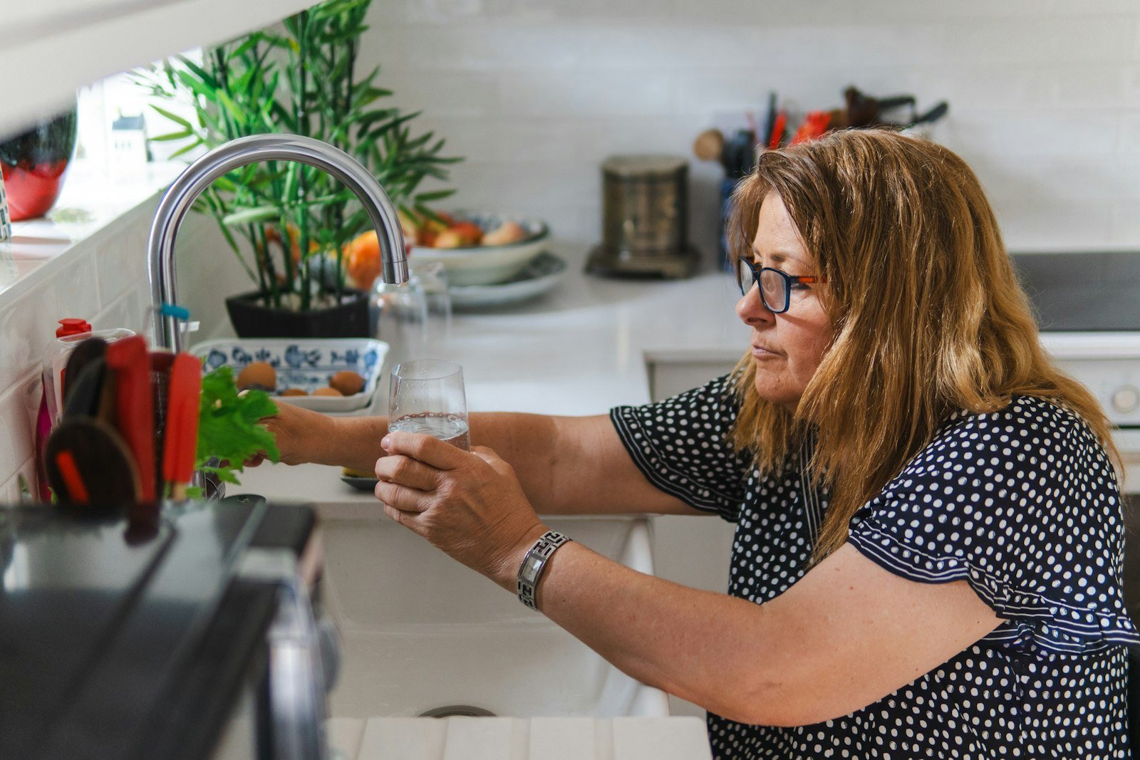 A person drinking a glass of water