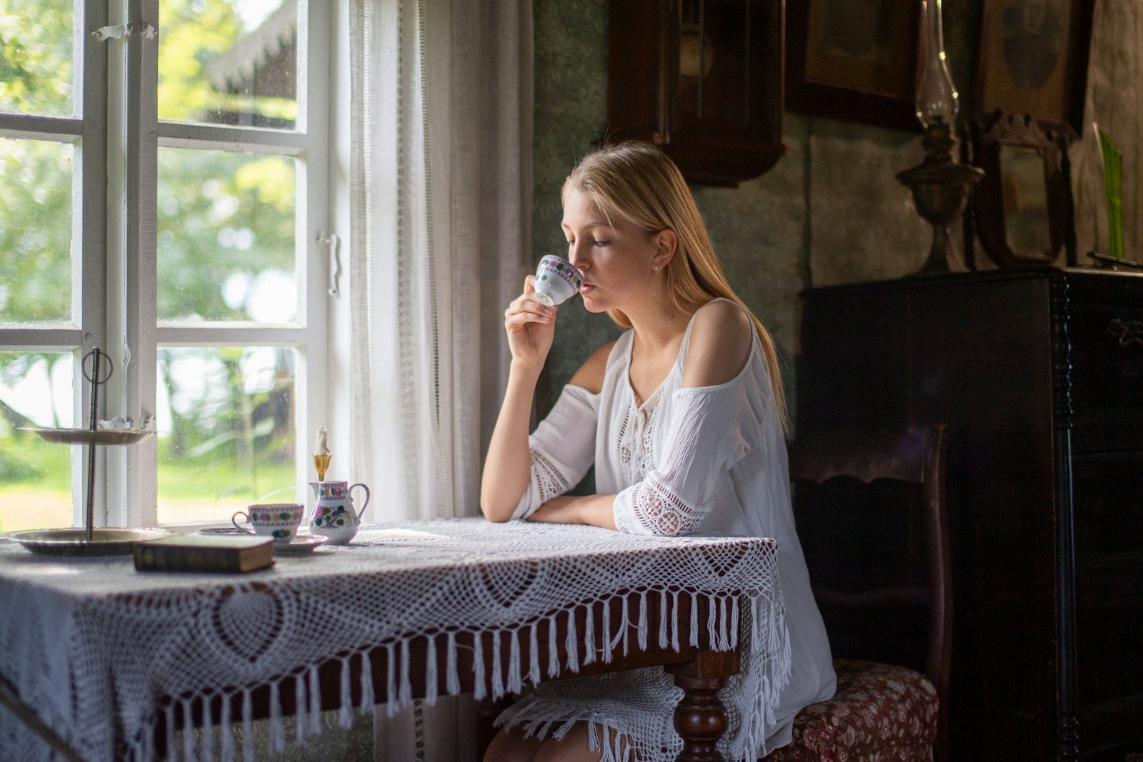 A person drinking a glass of water