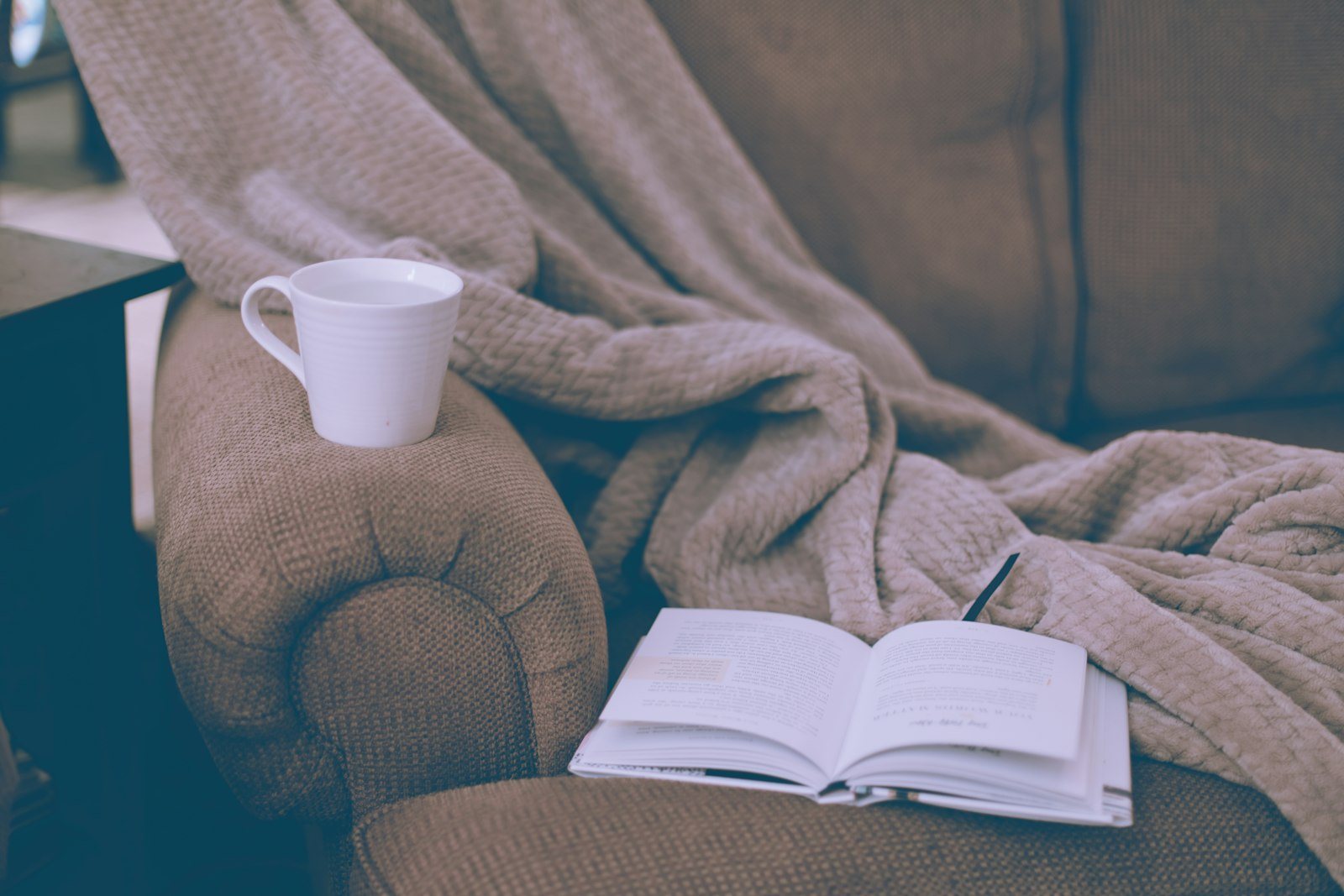 A person resting at home with a book