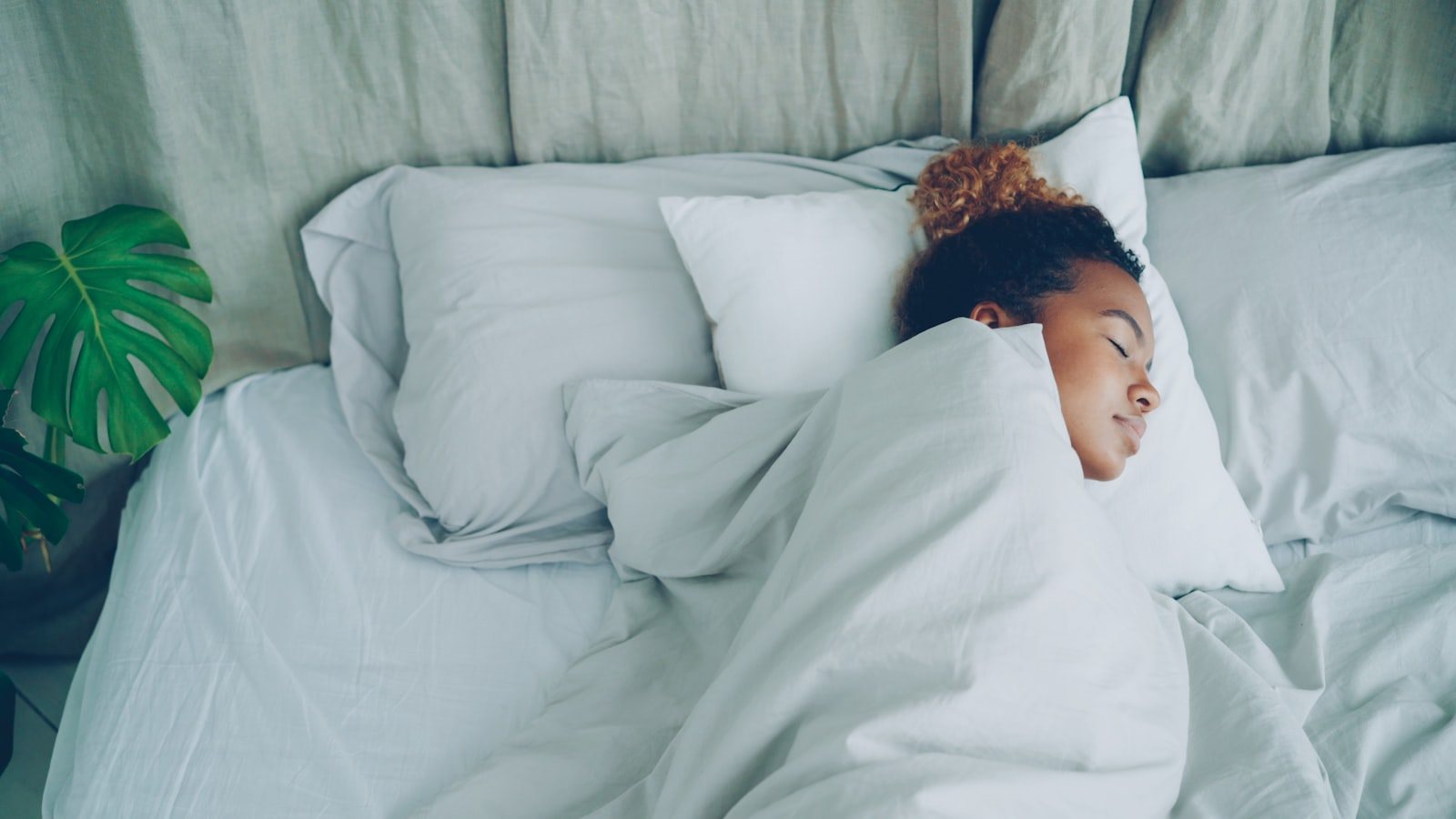 A person resting propped on pillows
