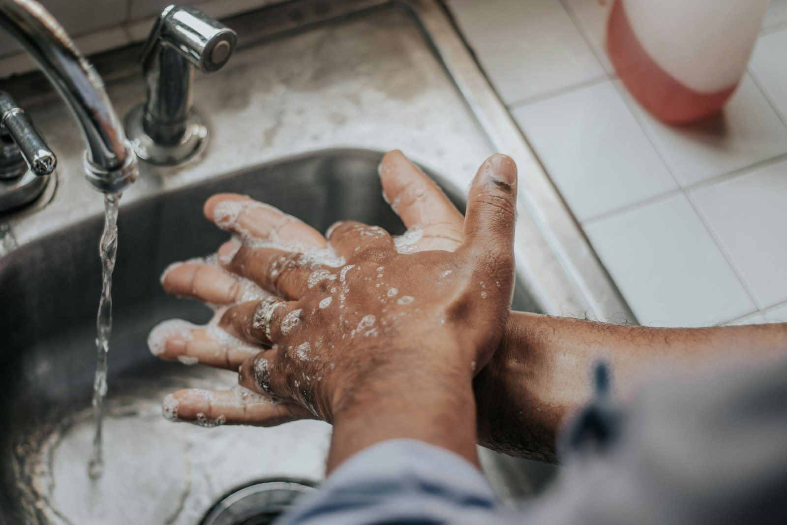 Hands being washed with soap