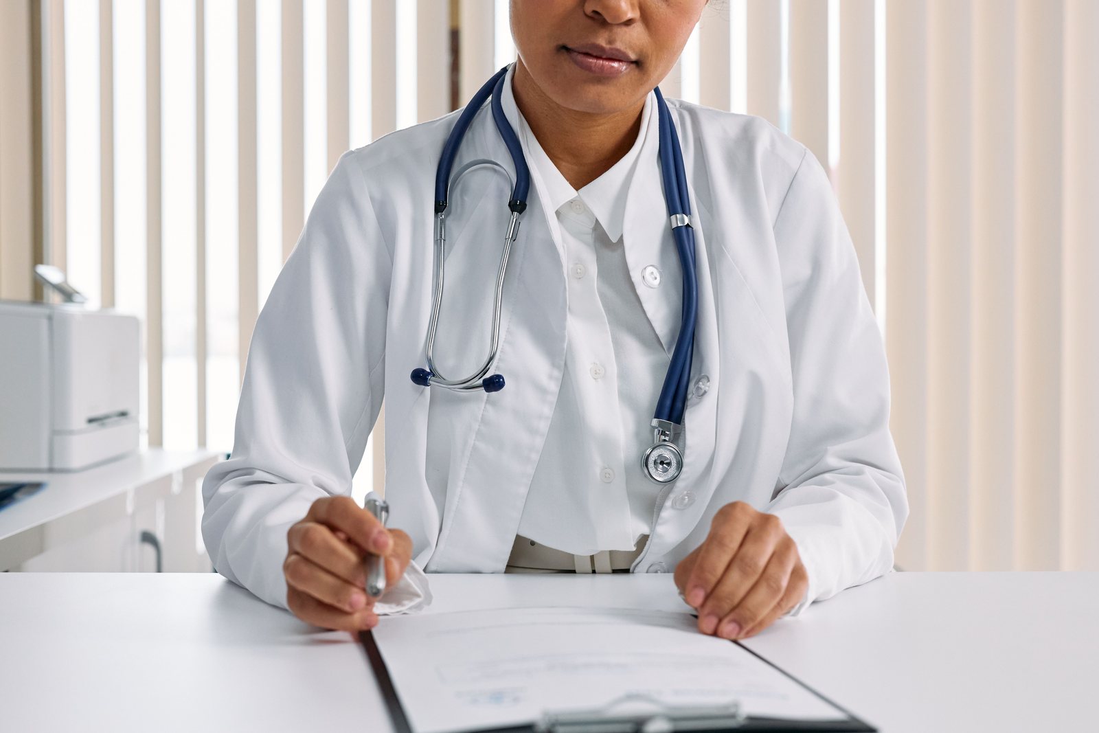 Medical notes and a stethoscope on a clinician desk