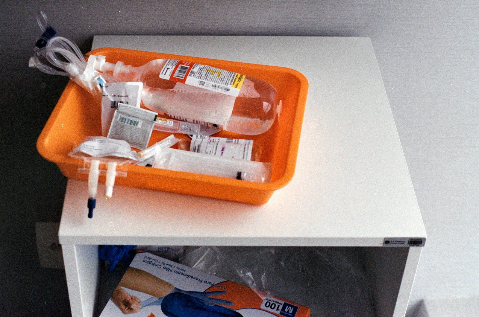 Intravenous fluid bags and syringes on a tray