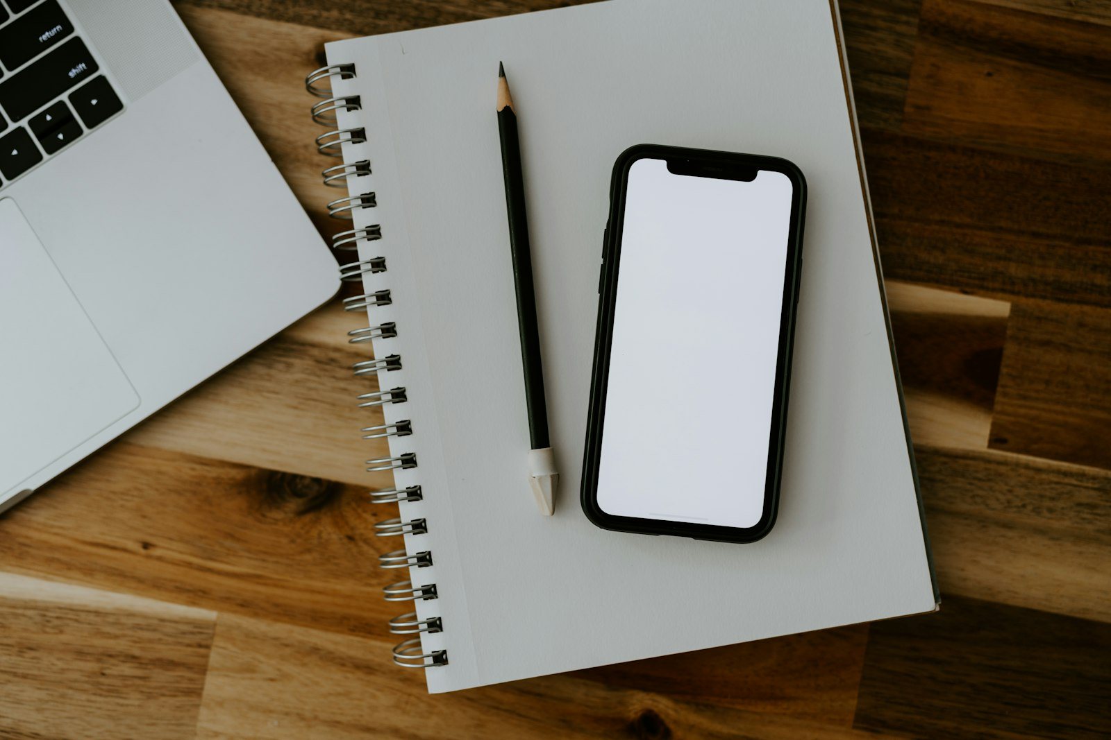 A phone and a notebook on a desk