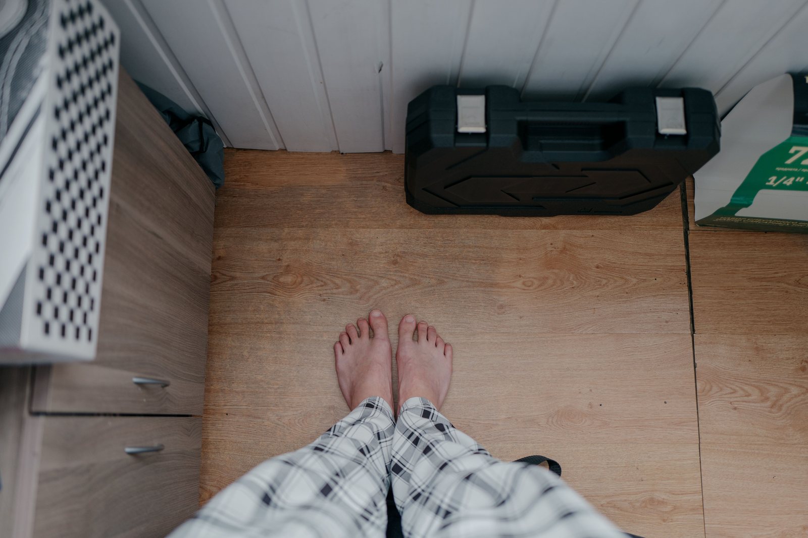 Bare feet on a bathroom floor