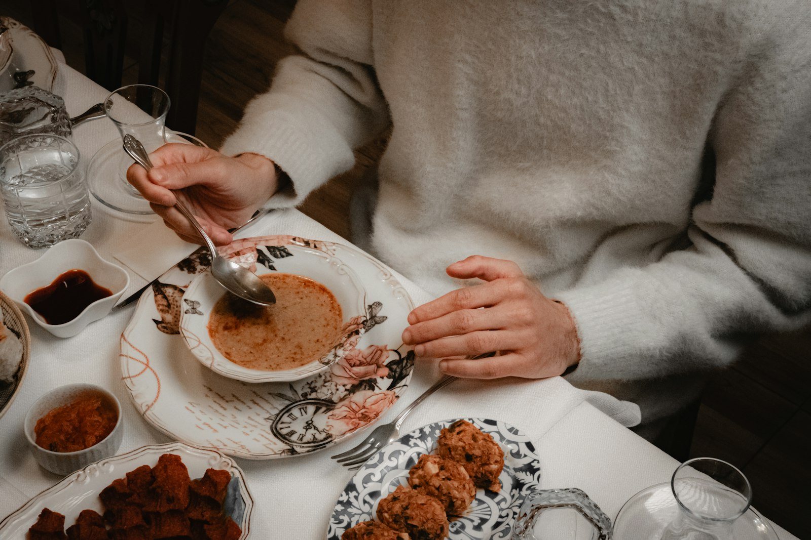 A person eating a bowl of soup