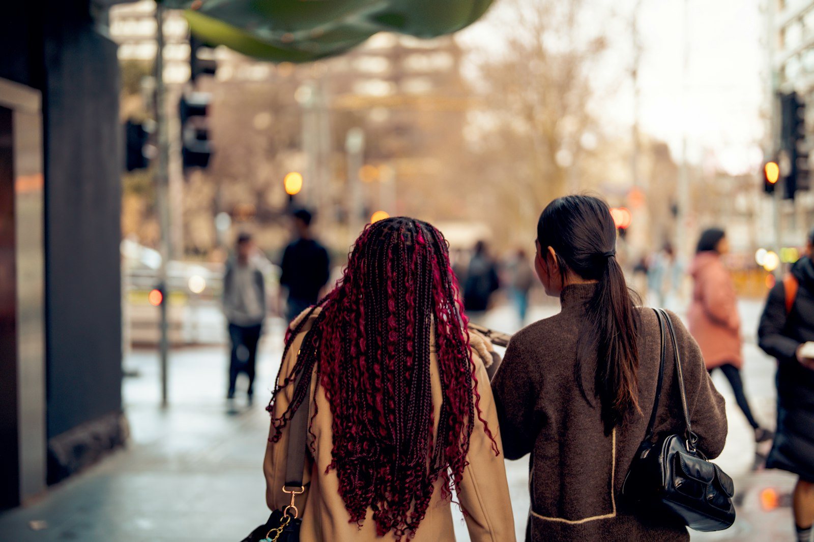 Two people walking together along a city street