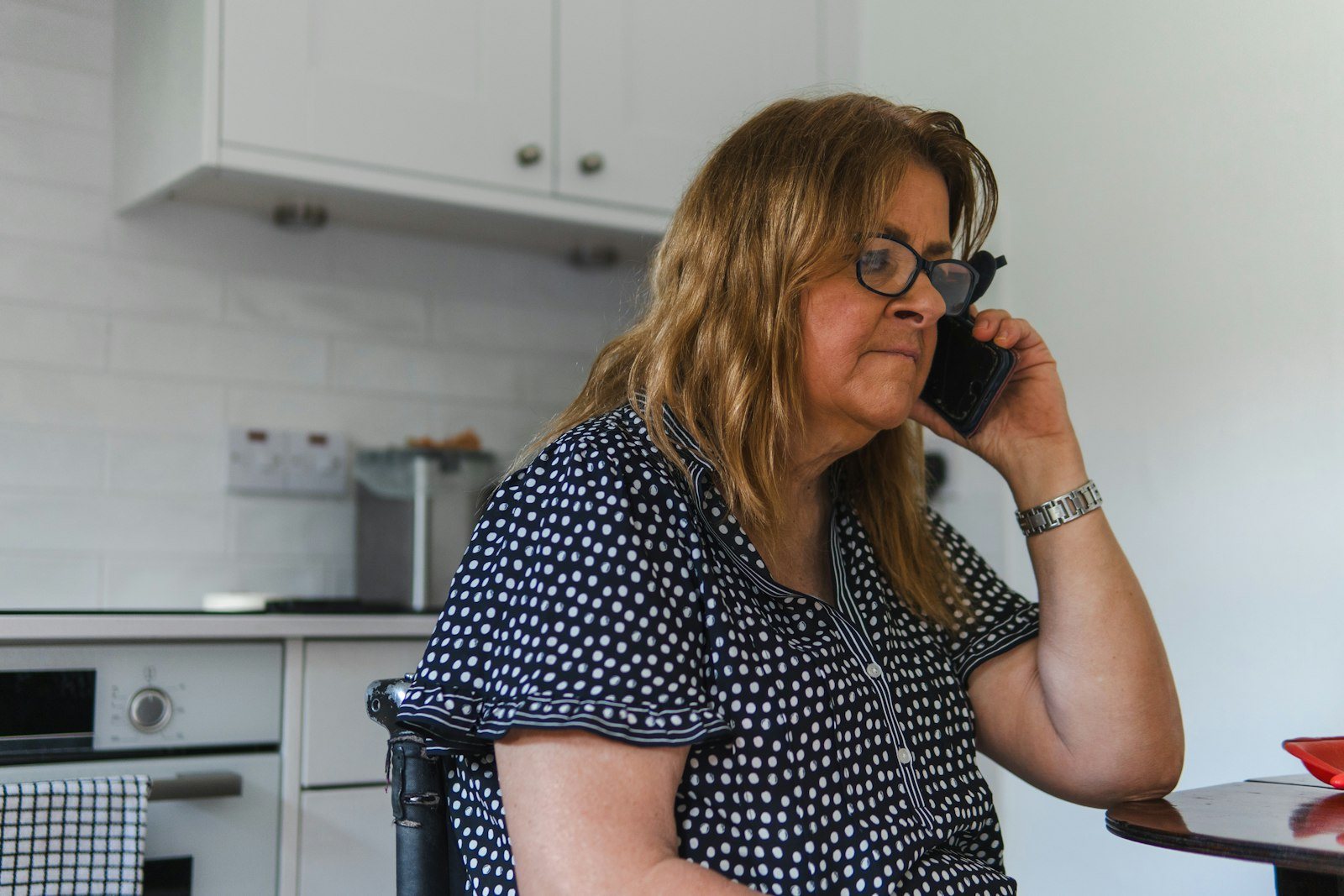A woman making a telephone call at home
