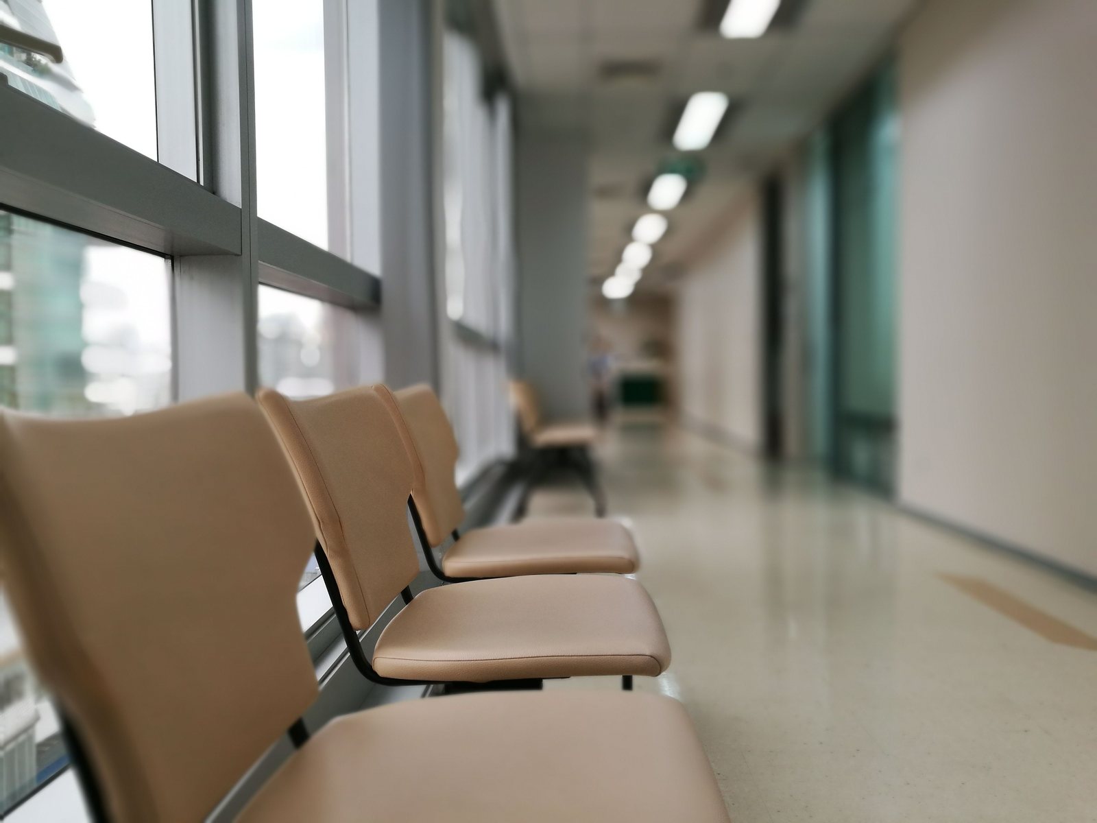 A row of empty chairs in a clinic corridor