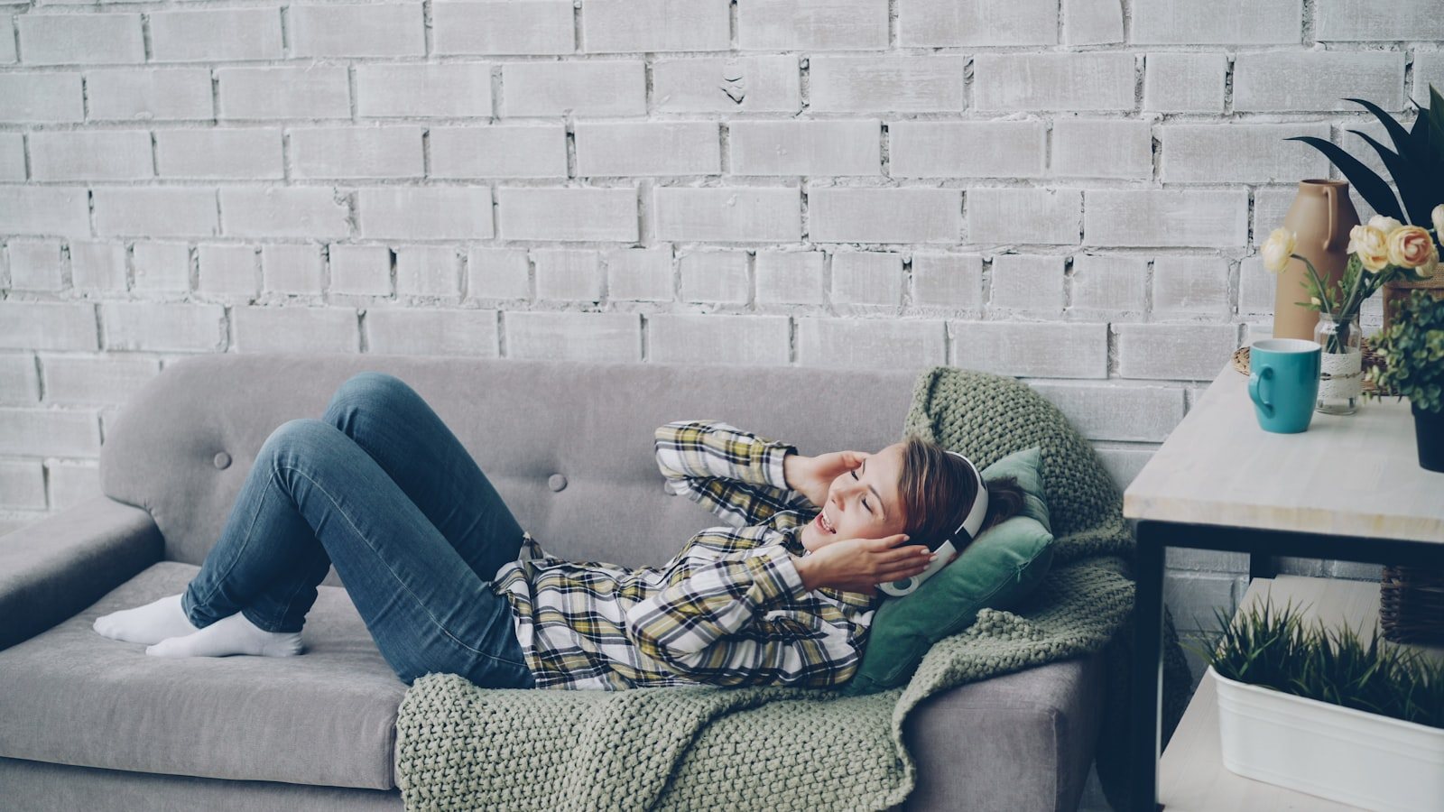 A young adult resting on a sofa at home