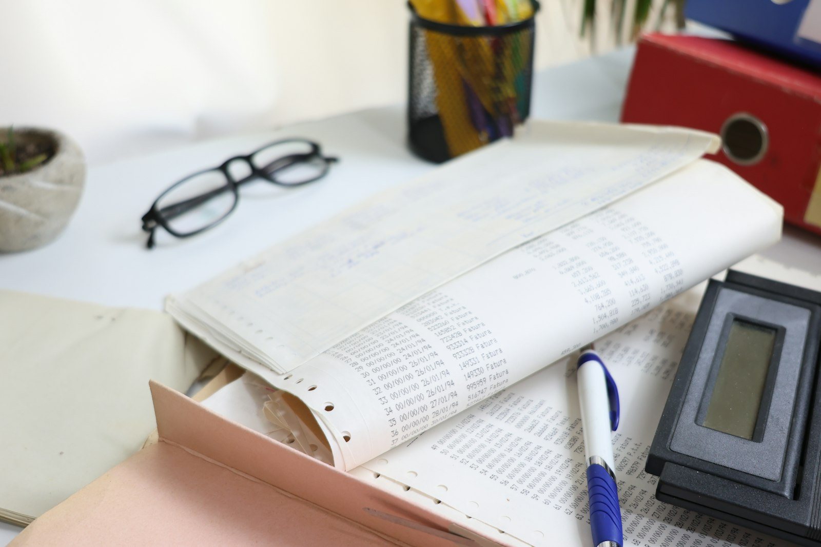 Open pages and reading glasses on a desk