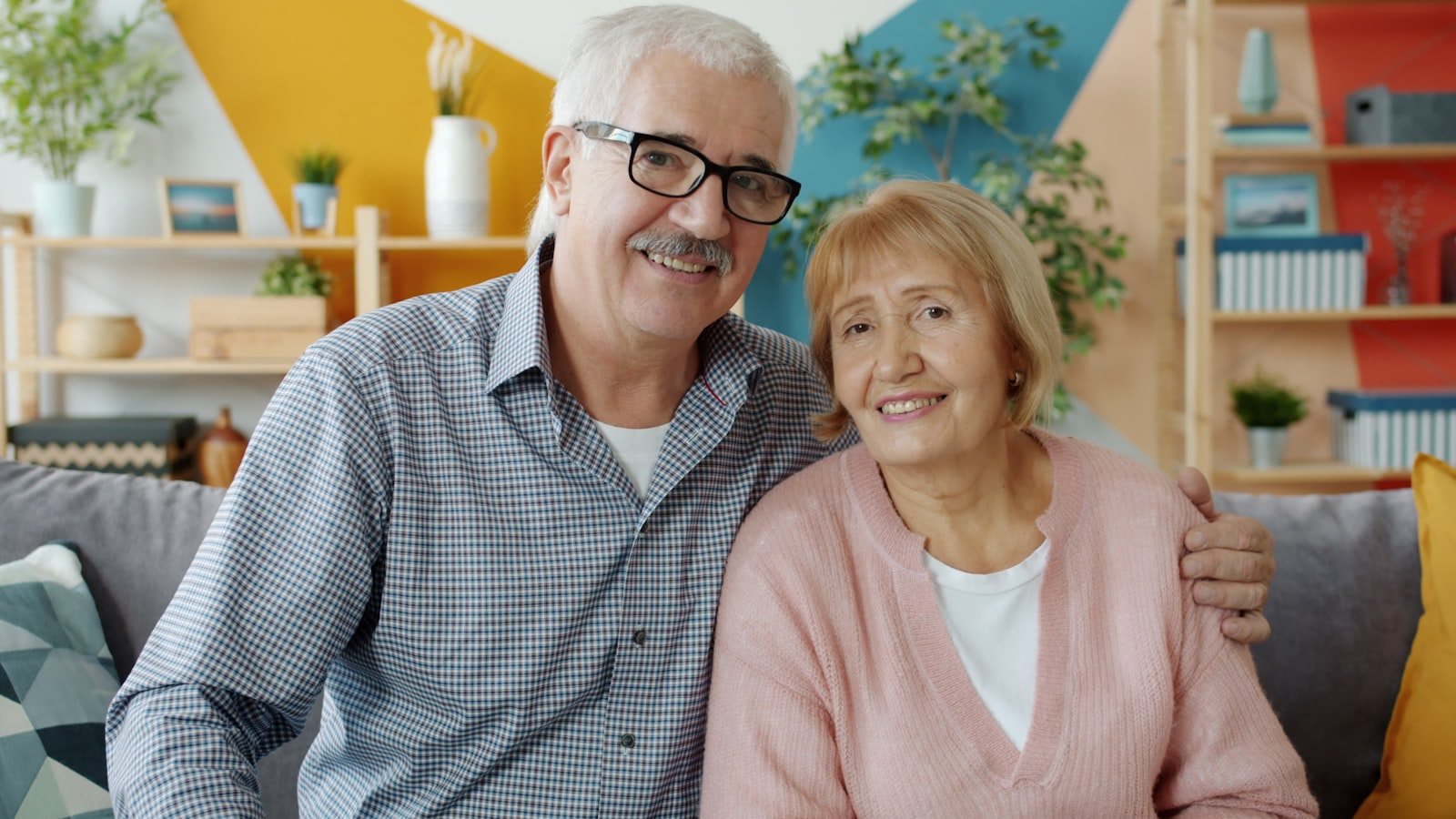An older couple sitting together at home