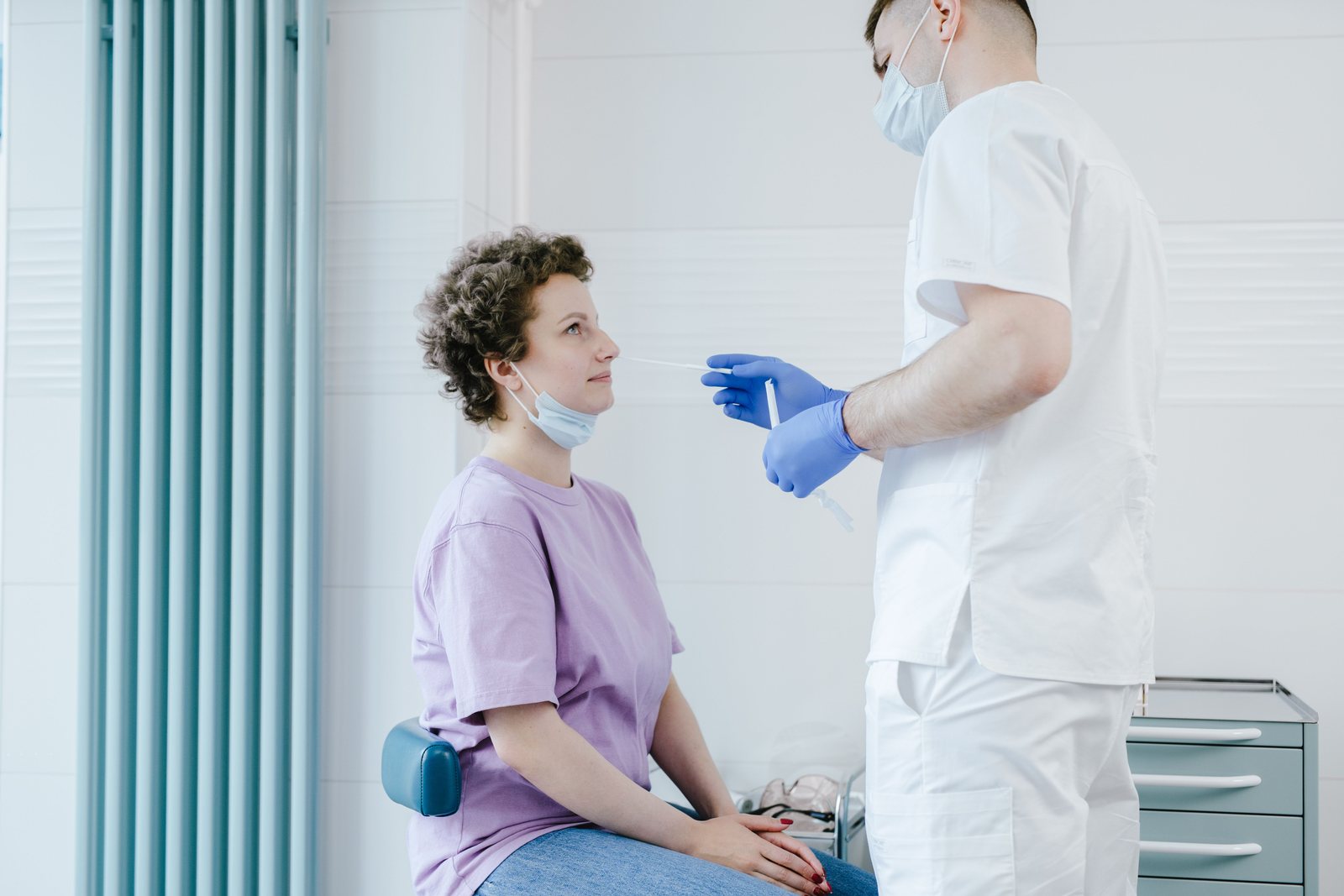 A patient being seen by a clinician in an examination room