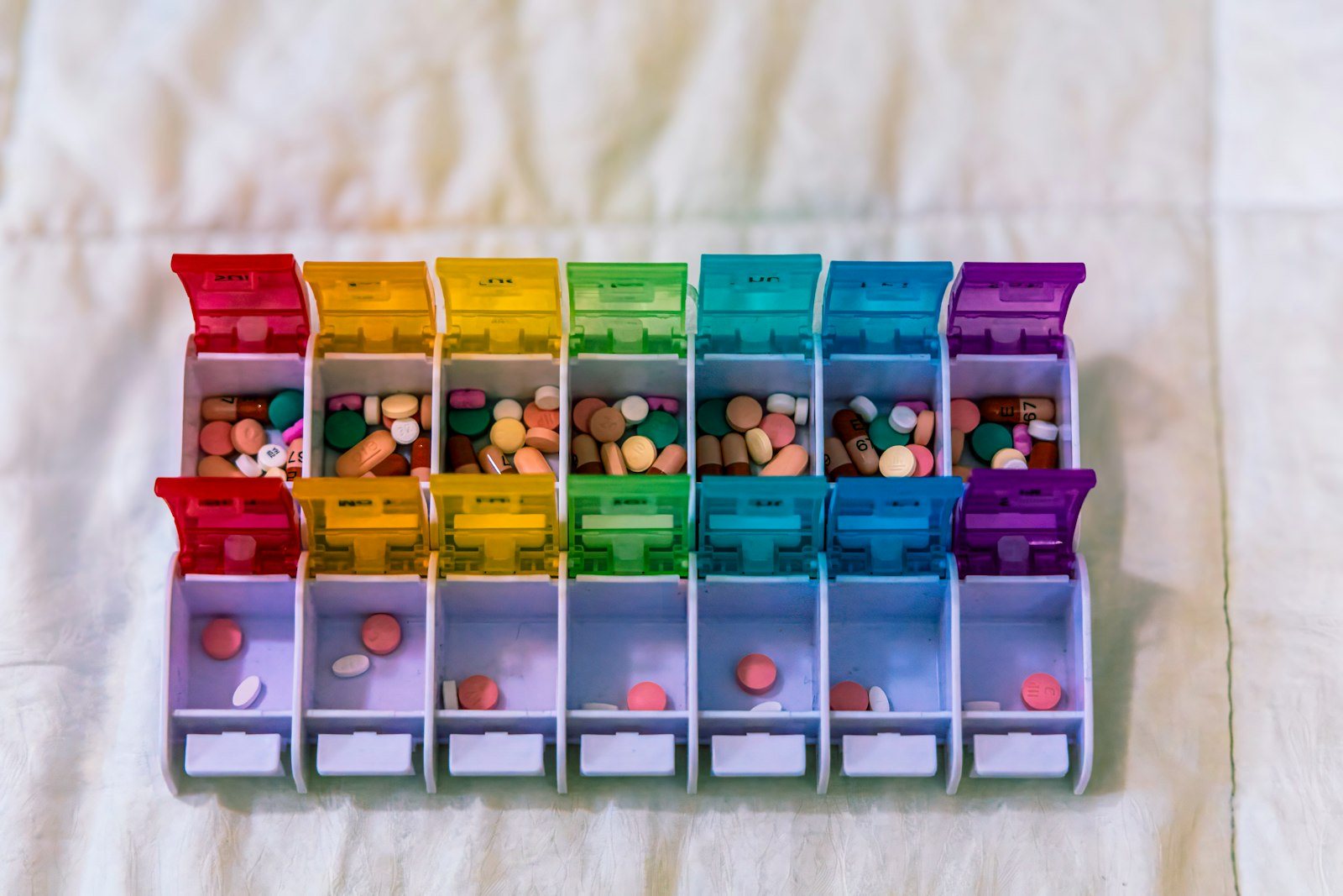 A weekly pill organizer filled with tablets