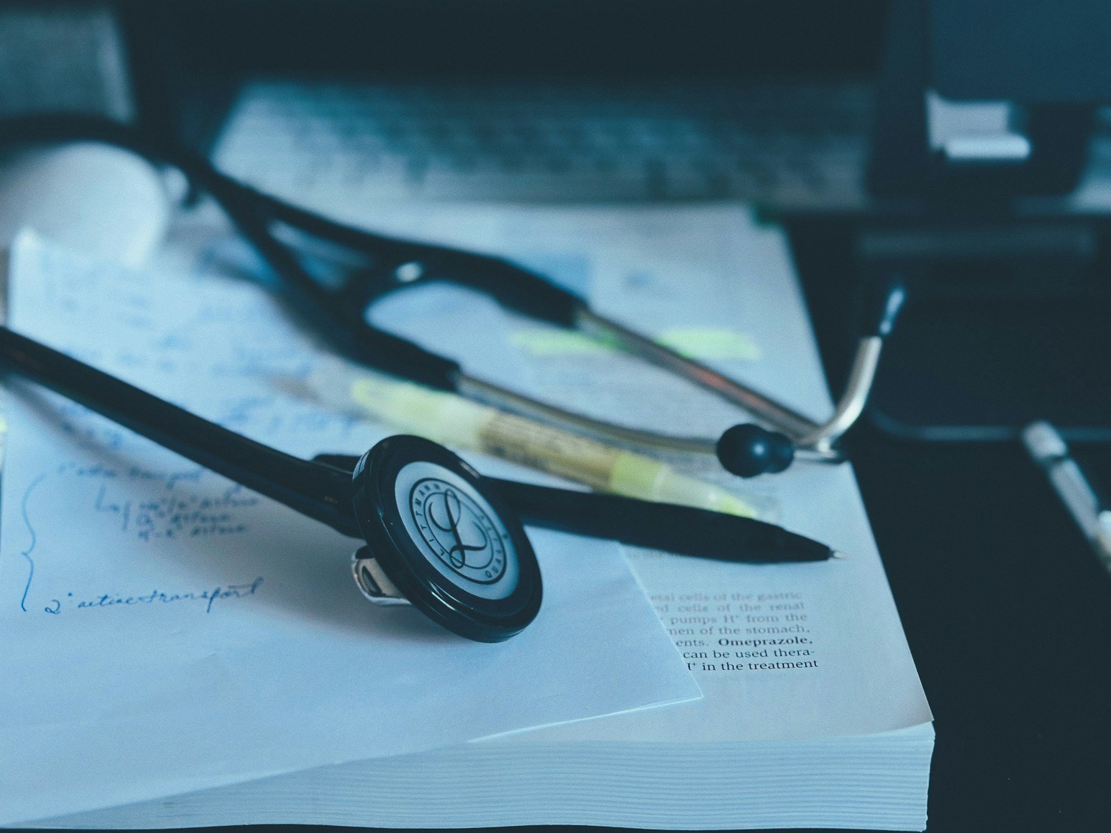 A stethoscope resting on paperwork on a desk